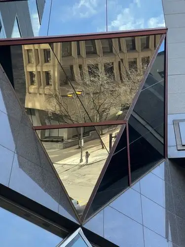 The city reflects its past in modern glass.